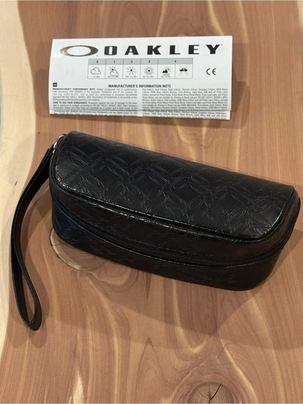 NWT Oakley Black Embossed Soft Sunglasses Case with wrist strap.